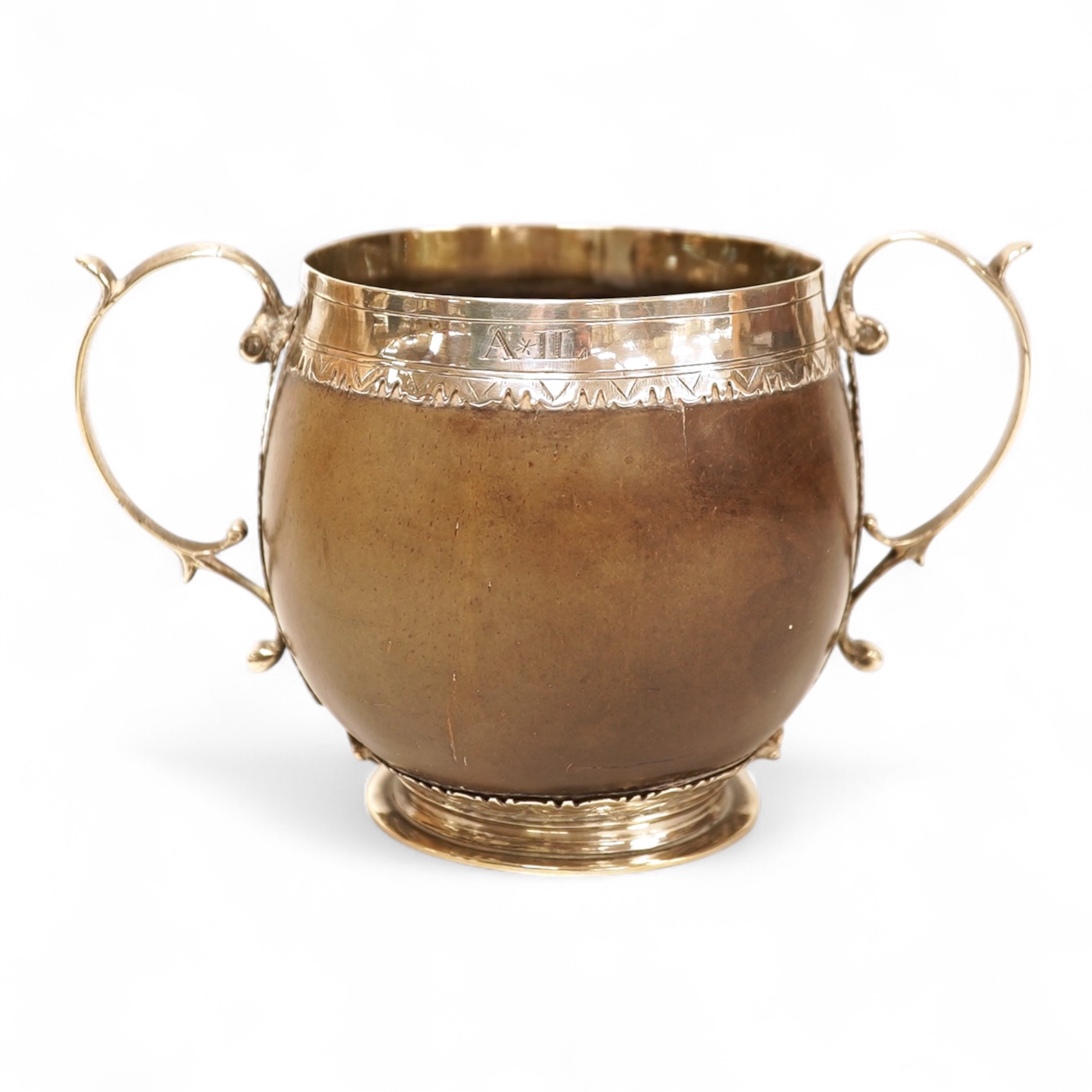 A late 19th/early 20th century white metal mounted two handled coconut cup, with engraved mounts and initials 'A IL', height 10cm (unmarked).